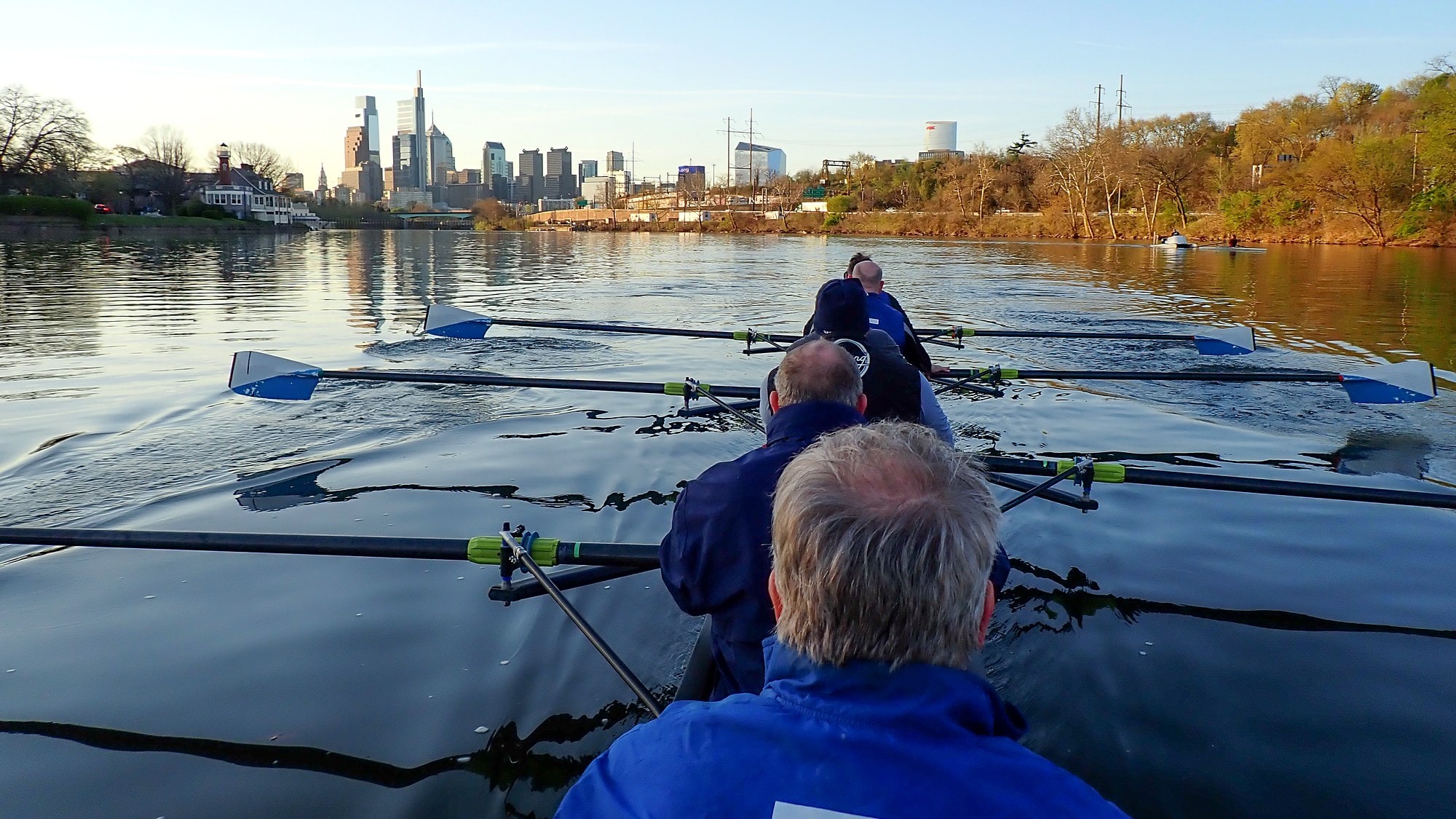 Fairmount rowers on the Schuylkill River with the Philadelphia skyline ahead